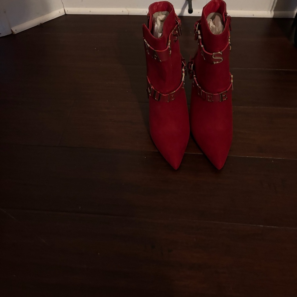 Brand new red mini boots with gold writing.